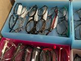boxes of glasses are stacked on top of each other on a table
