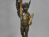 an image of a statue of a cupid holding a torch in his hand
