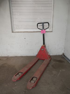 a fork lifter sitting in a garage with a window