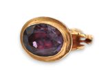 a close up of a gold ring with a purple stone