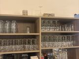 many glasses and plates on the shelves in the kitchen