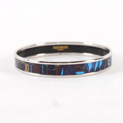 a close up of a bracelet with a blue and black design on it