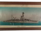 an old picture of a battleship in a frame on a wall