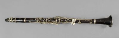 a close up of a clarinet on a white surface