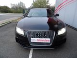 black audi car parked in a parking lot next to a building