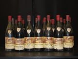 bottles of wine are lined up on a shelf in a wine cellar