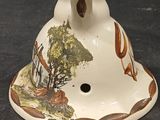 a white vase with a brown and white design on it
