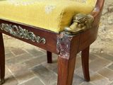 a chair with a lion head on the back of it