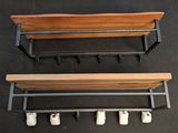 two wooden benches with wheels attached to them on a black surface