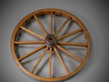 a wooden wagon wheel with a metal spoke on a wall