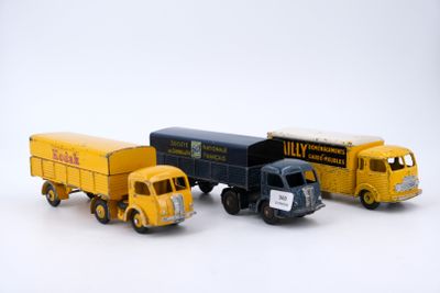 three toy trucks sitting next to each other on a white surface