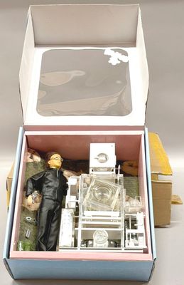 a box with a doll inside of it on a table