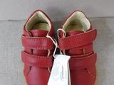 a close up of a pair of baby shoes on a couch