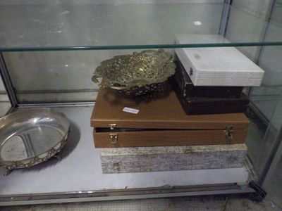 a glass display case with a silver bowl on top of it