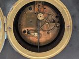 two clocks that are sitting side by side on a table