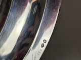 a close up of a silver plate on a table