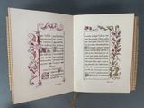 an open book that has a picture of a flower on it