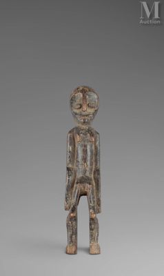 an image of a wooden statue of a man with a hat on his head