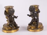 pair of bronze figurines of cherensils with cherensils on them