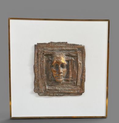 a close up of a sculpture of a man ' s face in a frame