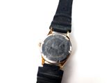 an image of a close up of a wrist watch on a white surface