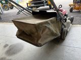 a lawn mower with a bag attached to it