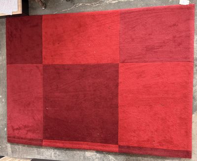 a red and black rug on display in a store