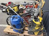 a pile of tools sitting on a pallet in a parking lot