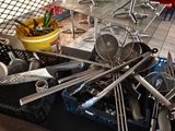 a pile of kitchen utensils on a table
