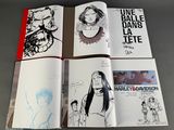 several pages of comics are spread out on a table