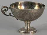 a silver cup that is sitting on a table