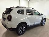 the rear end of a white suv parked in a garage