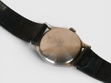 an image of a close up of a wrist watch on a white surface