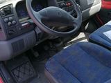 a red car with a steering wheel and a blue seat
