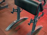 rows of red and black exercise equipment in a gym