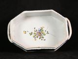 a small white bowl with a flower design on it