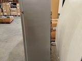 an image of a refrigerator in a warehouse with boxes in the background