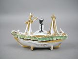 a figurine of a man and a woman in a boat