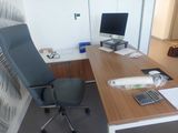 a desk with a chair and a computer on it