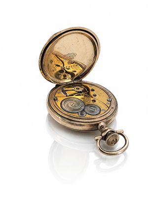 an antique pocket watch on a white surface with a white background
