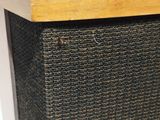 a close up of a speaker with a wooden top on a table