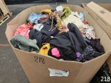 a cardboard box filled with clothes and other items