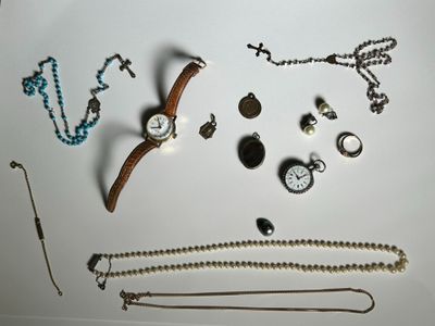 a lot of jewelry on a white surface
