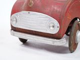 a red toy car that is sitting on a white surface