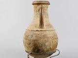 a vase on a stand with a handle on a white background