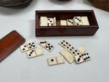 a box of dominos sitting on a table next to a pair of shoes