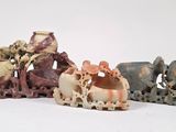 four small figurines of animals on a white surface