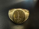 a close up of a gold signet with an eagle on it