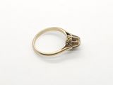 a close up of a gold ring with a diamond in the center