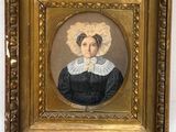 an antique portrait of a woman in a black dress with a white bonnet